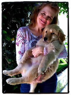 Me holding Daisy the Golden retriever at 12 weeks