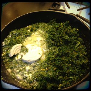 Adding coconut milk to curried greens